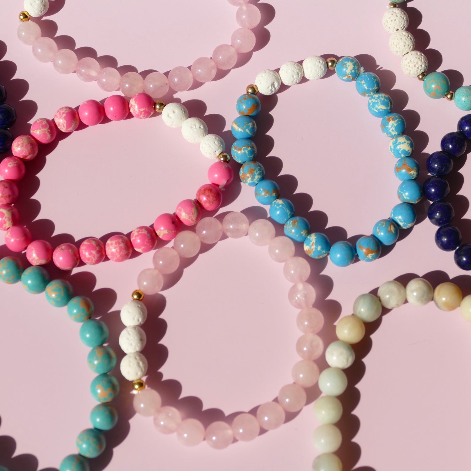 Pink background with bracelets